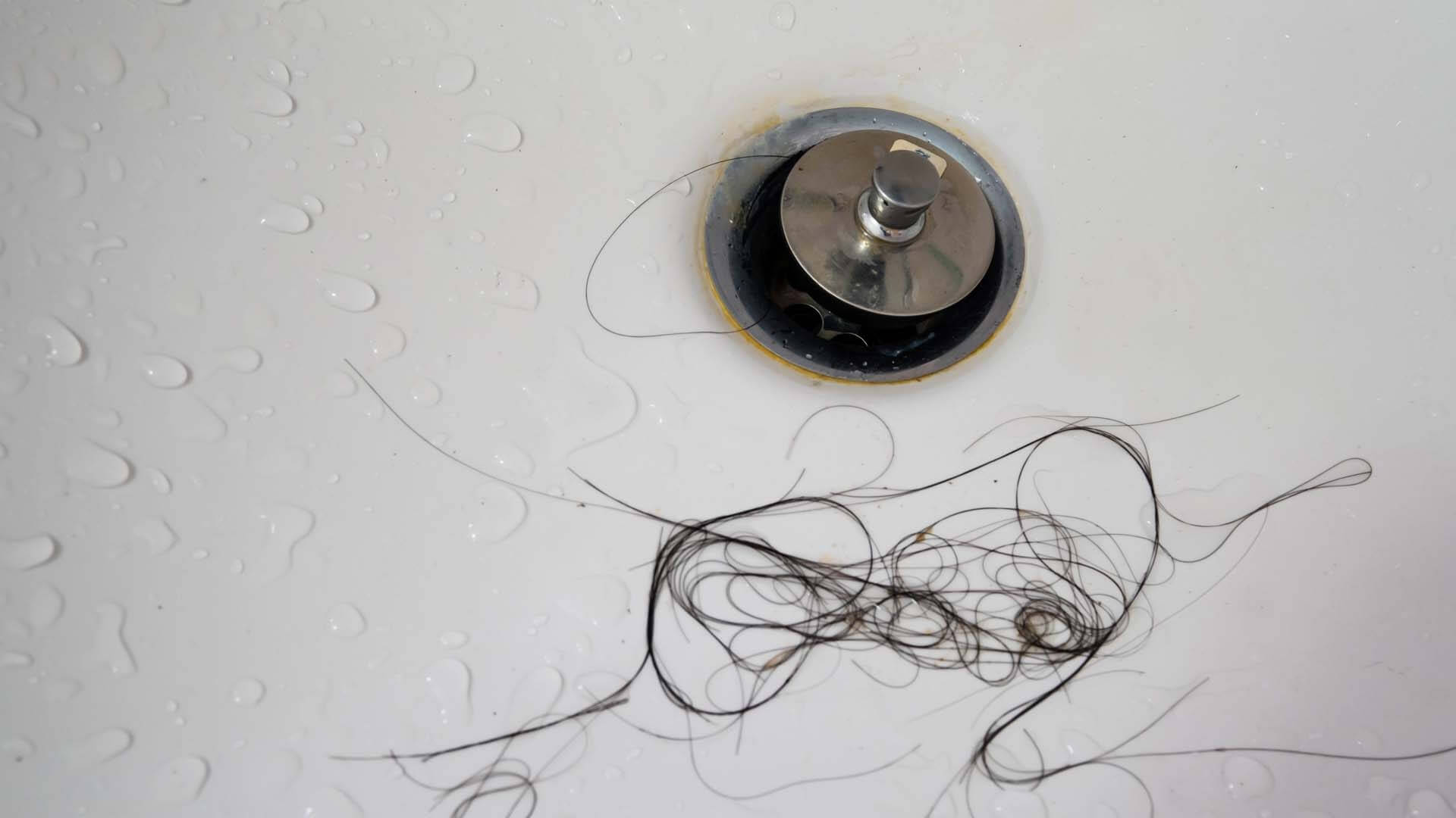 Bathtub drain clogged by hair at home in Davenport, FL.