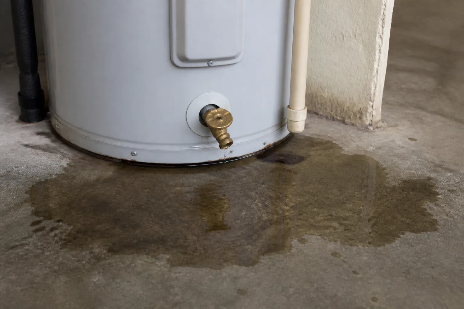 Water heater leaking at the base in a Lakeland home before a permitted replacement